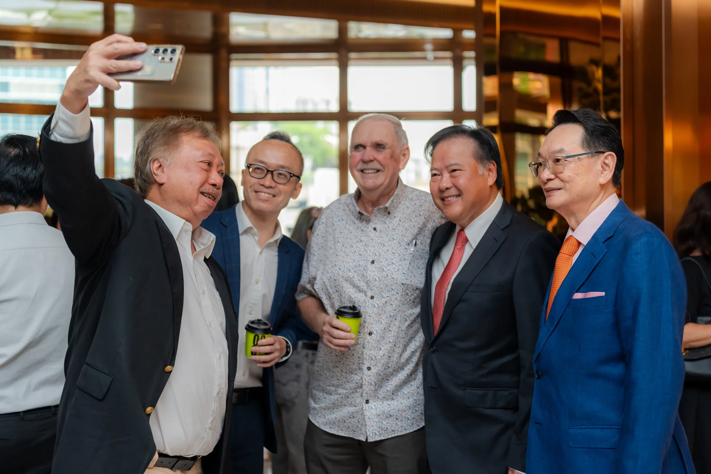 Candid event photograph from the opening of St Giles Hotel Mid Valley, featuring Tan Boon Lee, UFG Group CEO, standing with invited guests and business leaders.