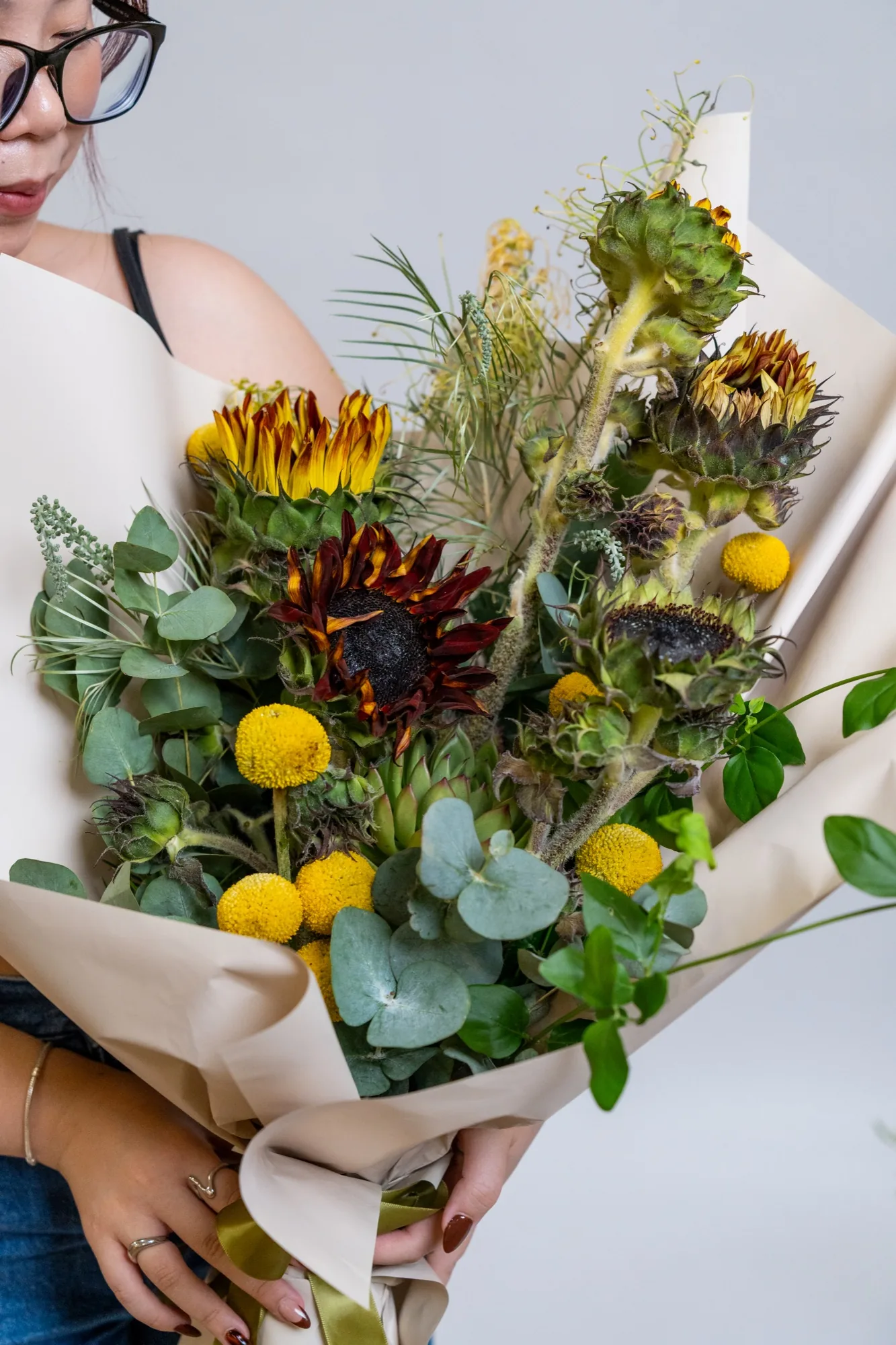 Photo of Elle holding flowers from Amtrol Flower Designing, International Award Winning Florist, at the StoryArc Studio opening.